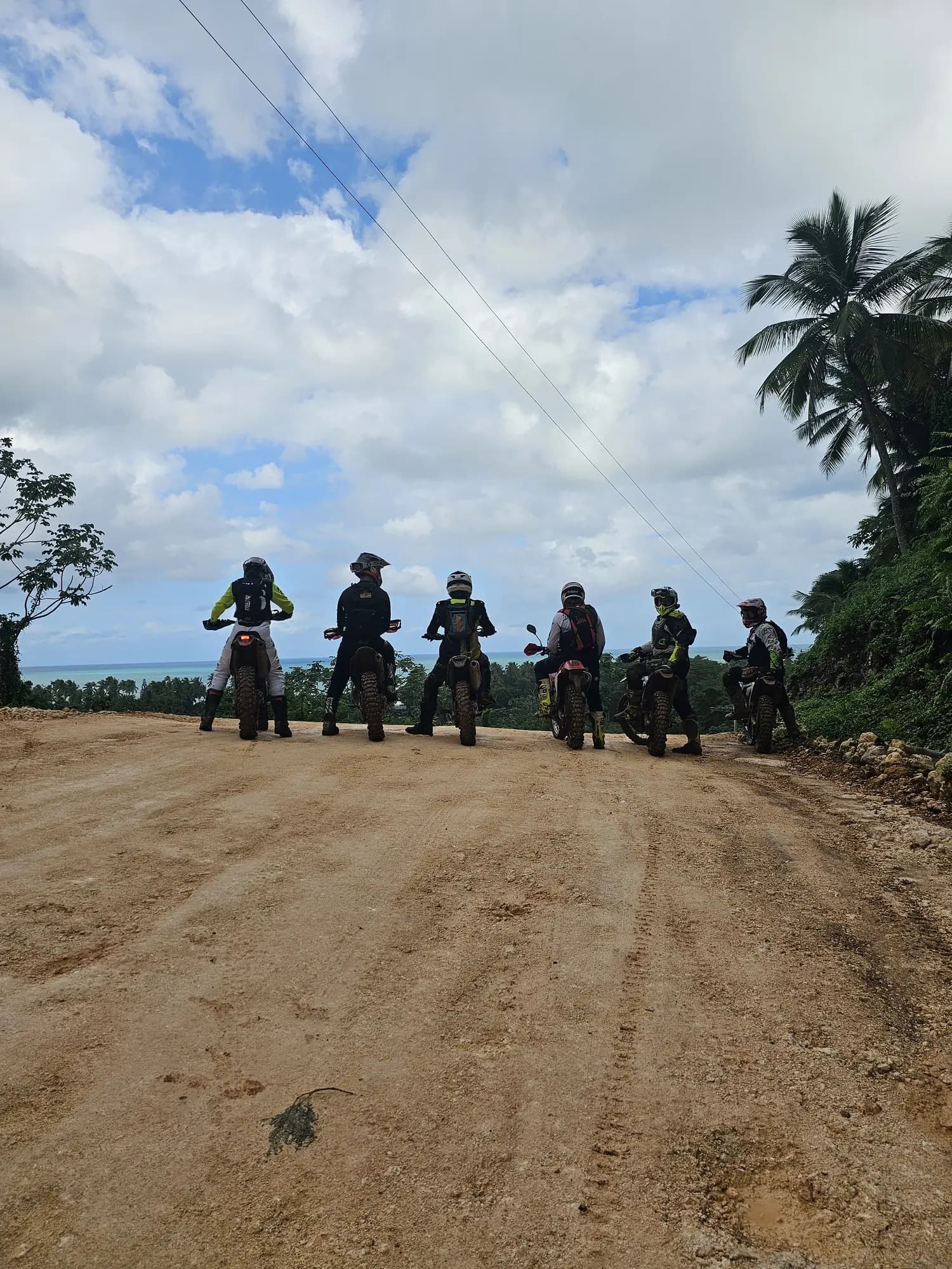 Riders lined up on a countryside dirt road