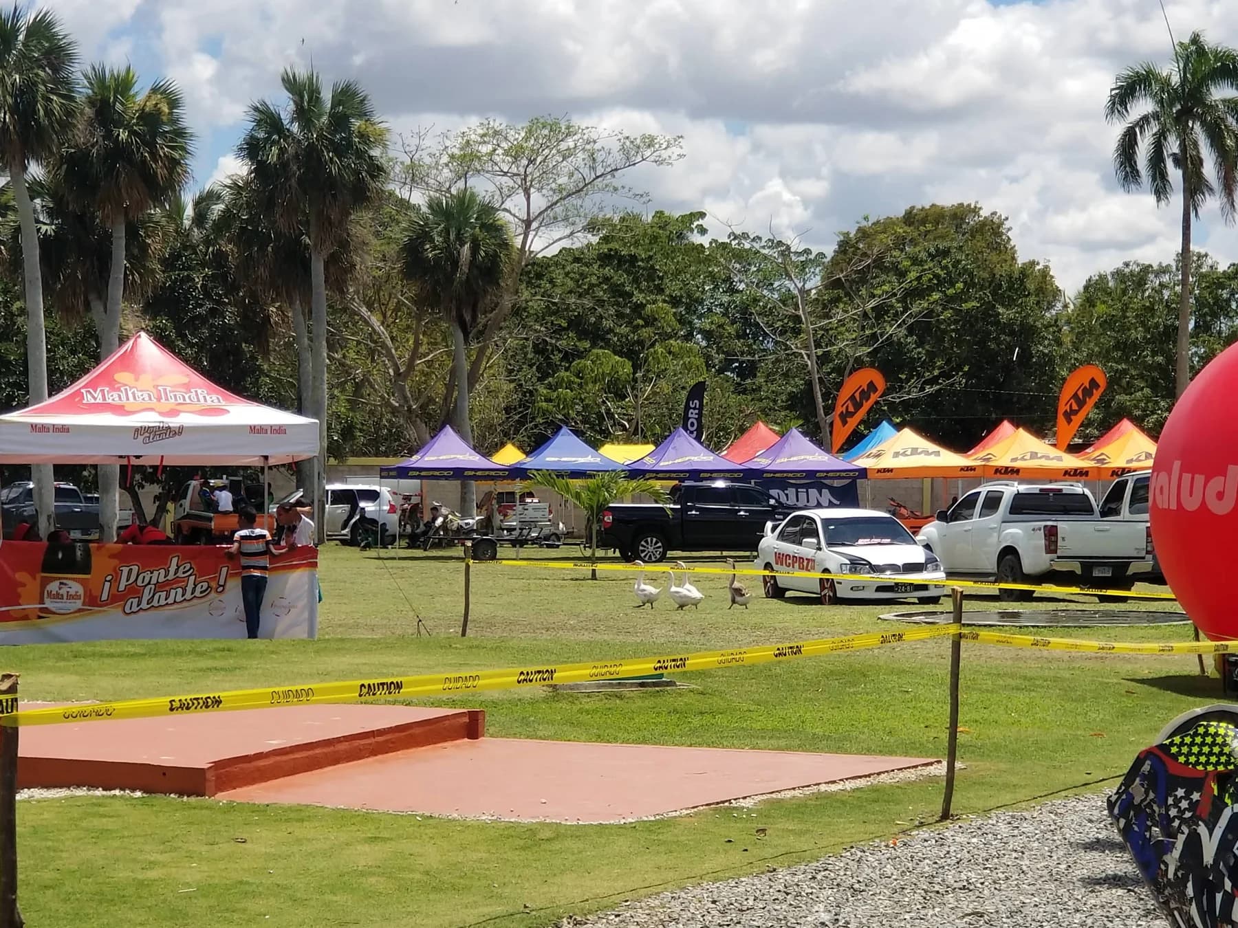 Paddock of a Dominican enduro event with team tents and bikes