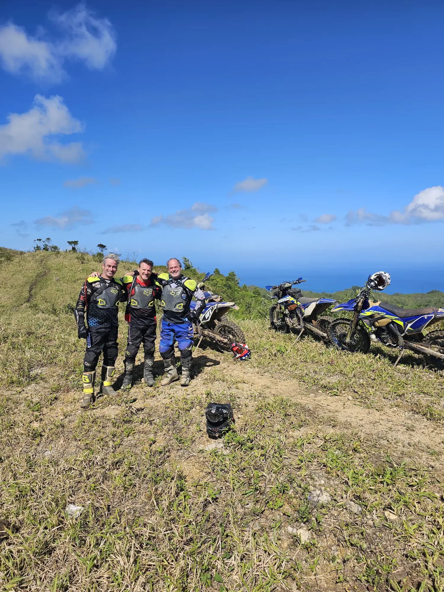 Group on a grassy ridge with ocean views