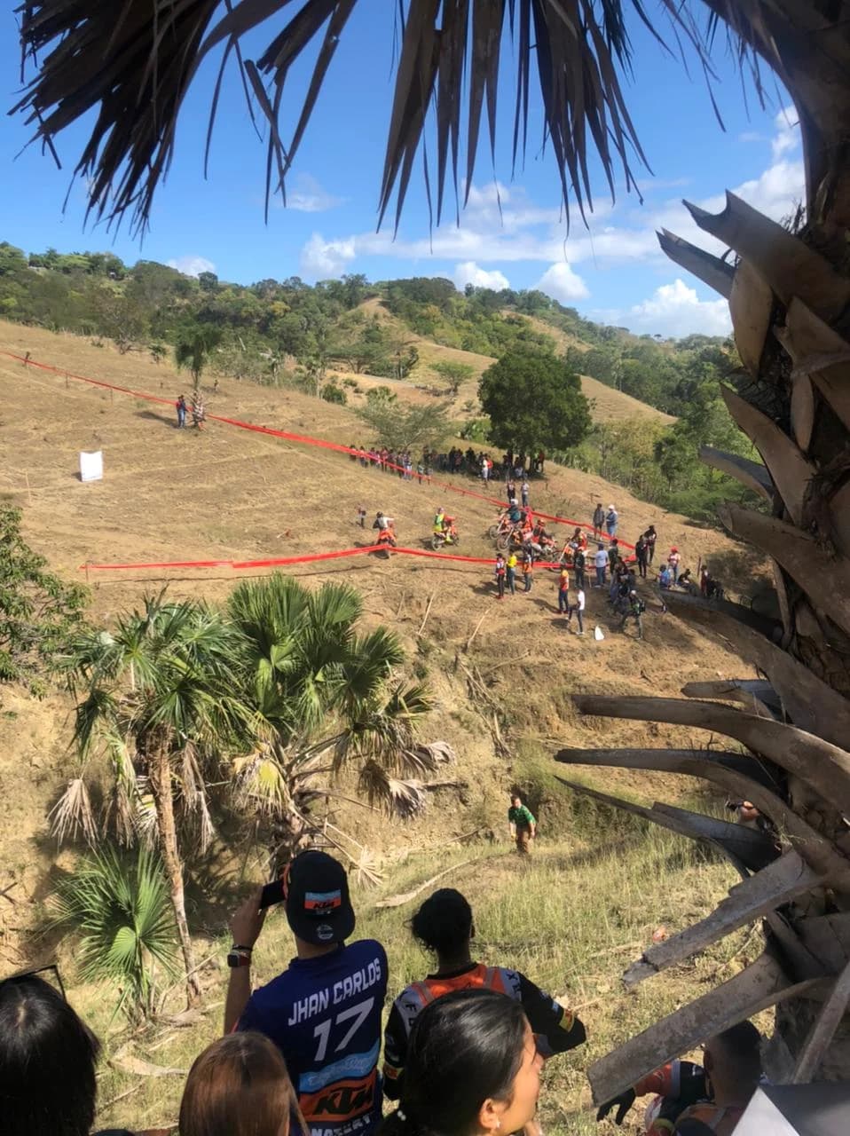 Hard Enduro race in the Dominican Republic: riders on a steep taped course with spectators