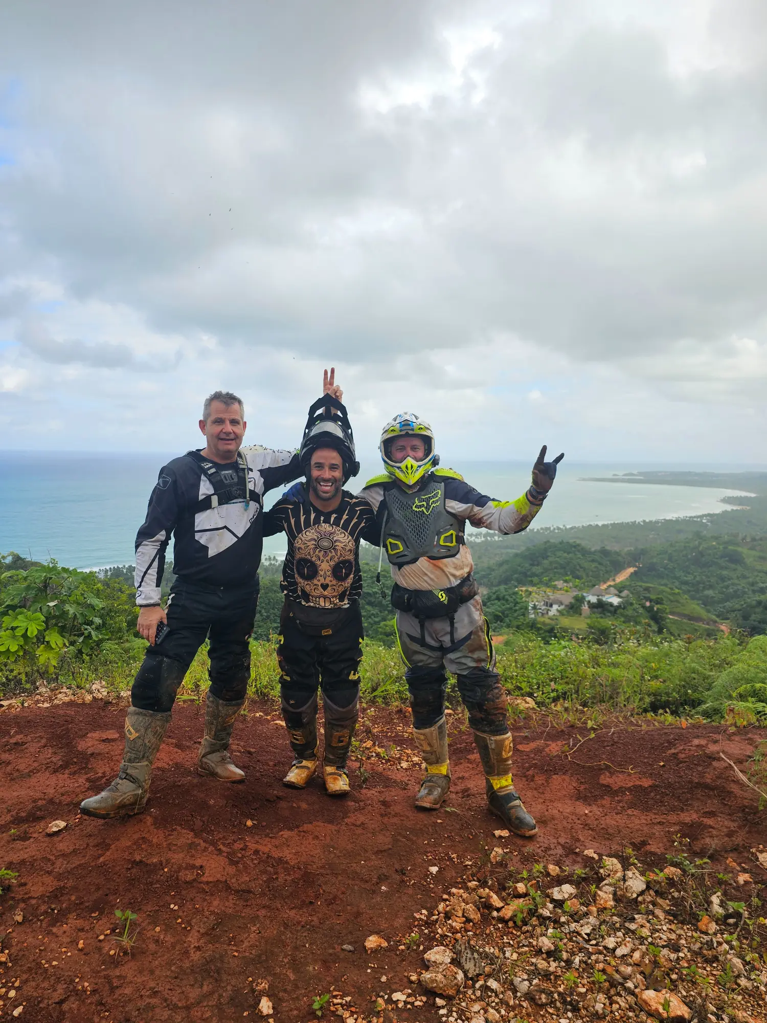 Riders celebrating on a hilltop above the bay