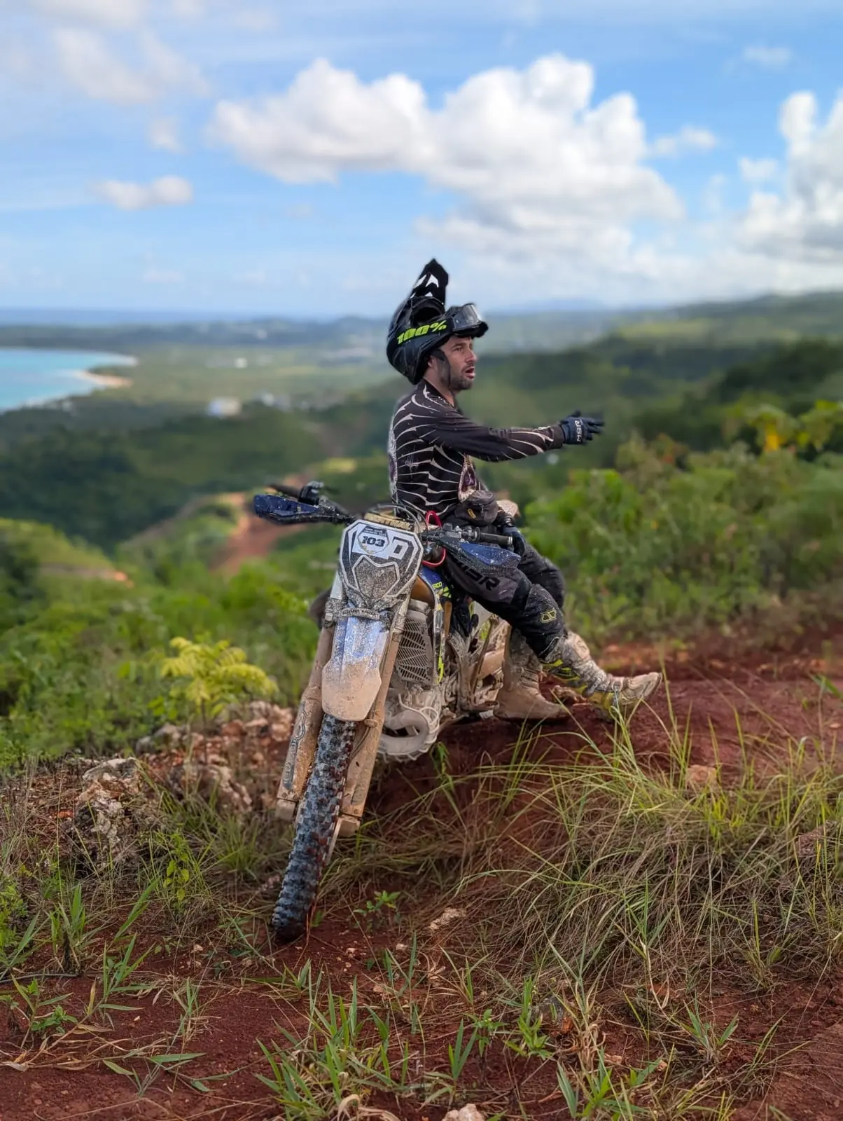 Rider pointing out the view from a hilltop