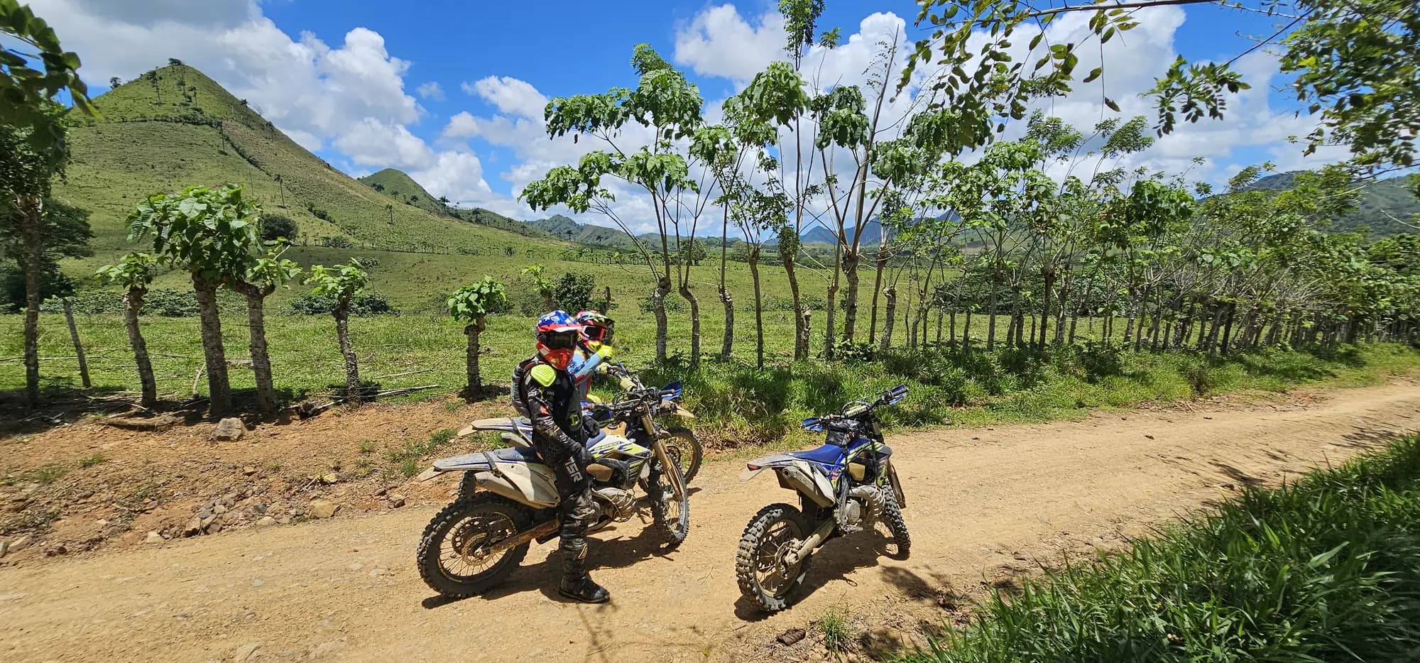 Two riders on a mountain dirt road