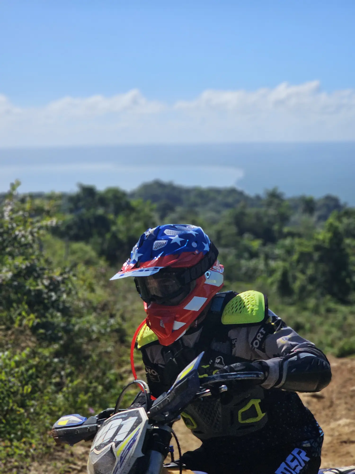 Rider in full gear above the jungle canopy