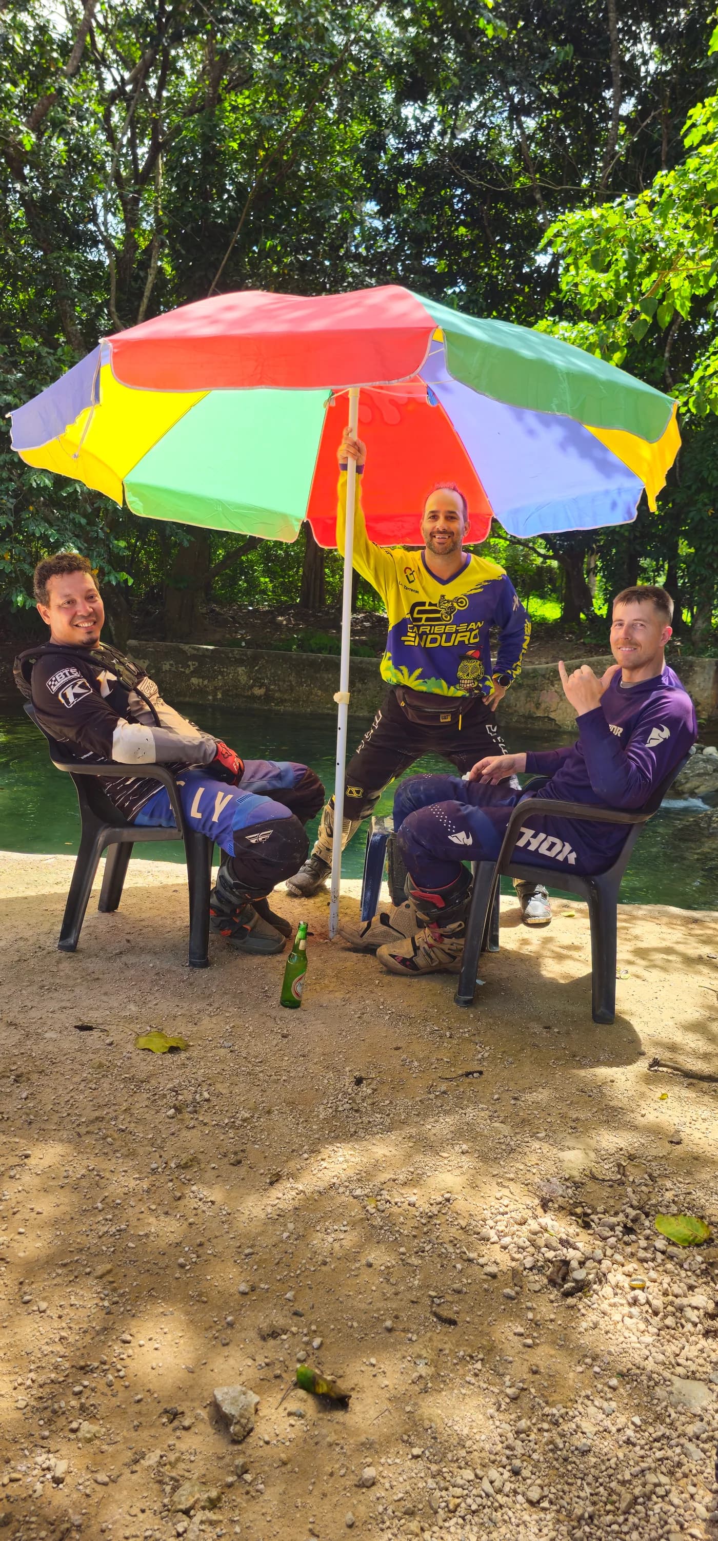 Riders taking a lunch break under beach umbrellas by the river