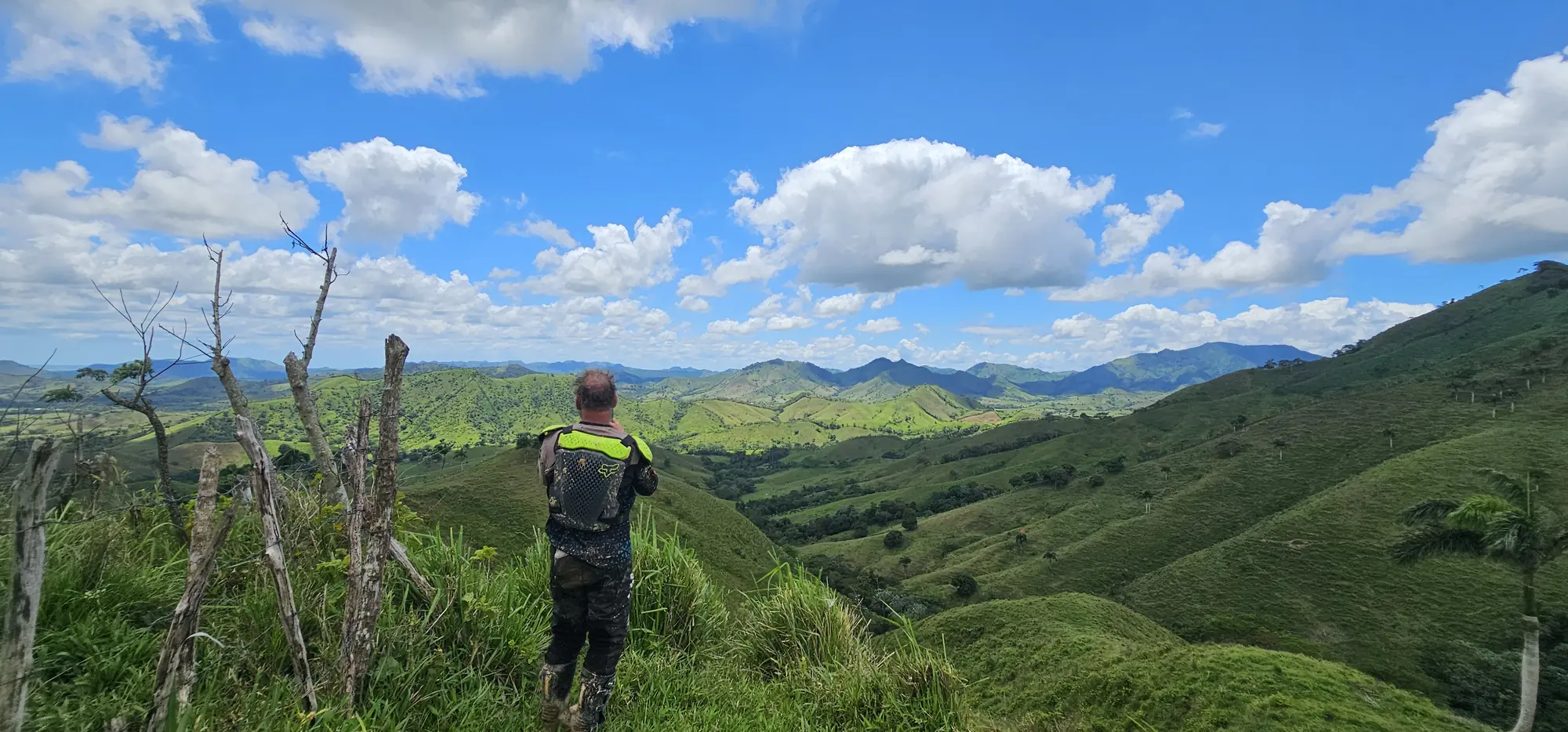 Rider looking over green valleys