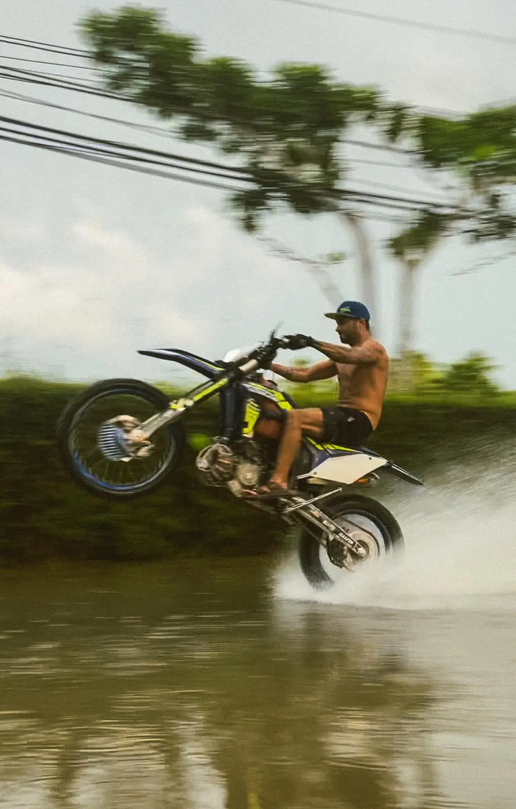 Rider splashing through a flooded road